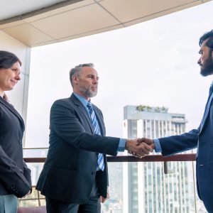 Chief executive officer with secretary meet up with business man Chief executive officer with secretary meet up with business man at the rooftop balcony discuss on business investment